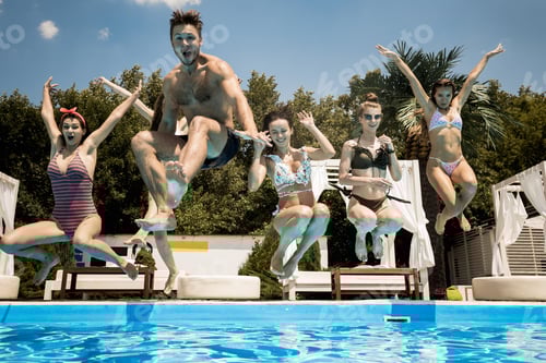 Preview: Funny company of young girls and guy jump into the swimming pool on the open air on a sunny summer