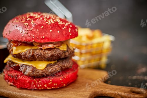 Preview: Homemade red sesame bun double bacon cheese burger. Served with french fries on wooden board