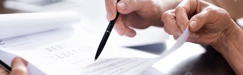 Preview: Panoramic crop of senior couple holding papers with debt collection lettering and pen