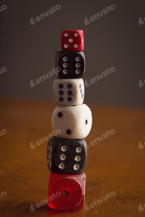 Preview: different size and color rolling dices on wooden background