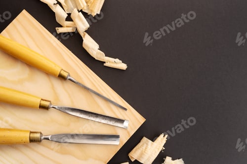 Preview: Set of gauges on wooden plank on black background. Woodworking or carpentry flat lay