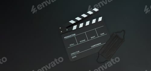 Preview: Clapper board or movie slate with black face mask or medical mask isolated on black background.