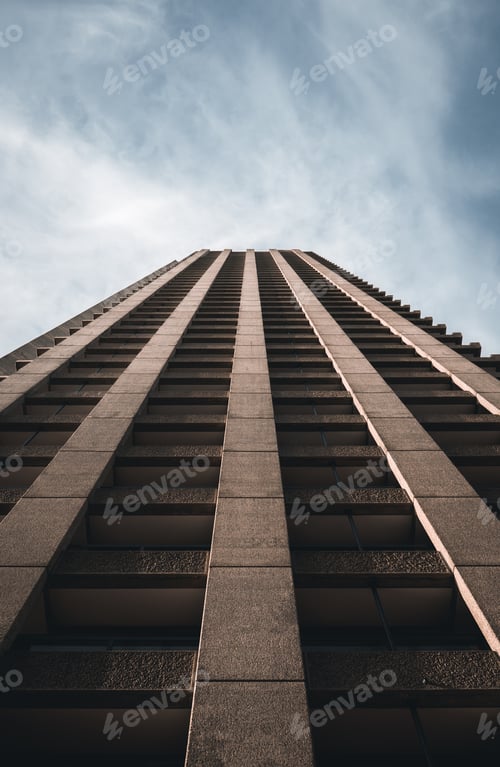 Preview: Low angle shot of a brown skyscraper under a gloomy sky in London