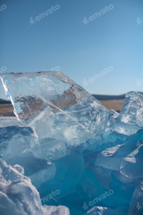 Preview: Pieces of ice lying on the ideal smooth ice of baikal with ice hummocks in the horizon