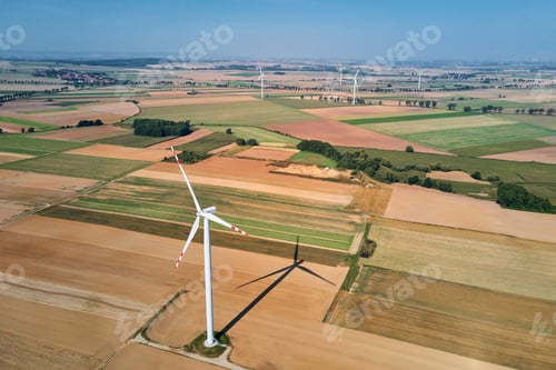 Preview: Windmill turbine in the field at summer day. Rotating wind generator