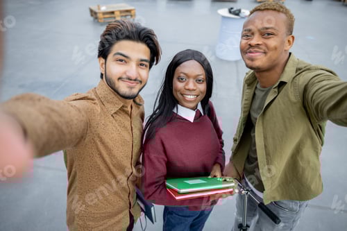 Preview: Students looking at camera at university campus