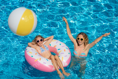 Preview: Happy family playing in outdoor pool
