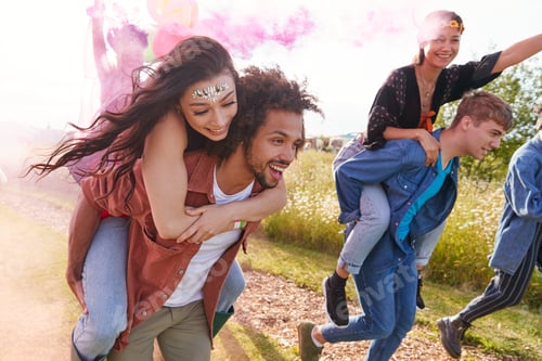Preview: Group Of Friends Walking Back To Tent After Outdoor Music Festival With Balloons And Smoke Flare