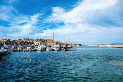 Preview: Venetian harbour in Old Town of Chania Crete Greece. Moored boat at marina, beacon, sea, blue sky.