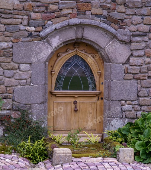 Preview: Entrance of an ancient farmhouse with a wooden door in Normandy, France