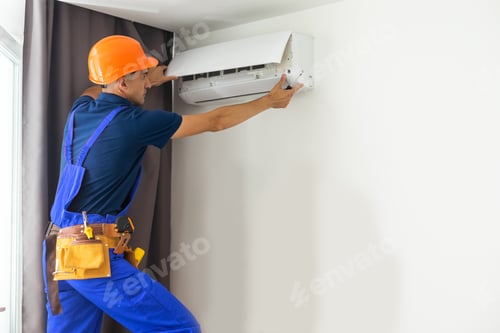Preview: Male technician repairing air conditioner indoors