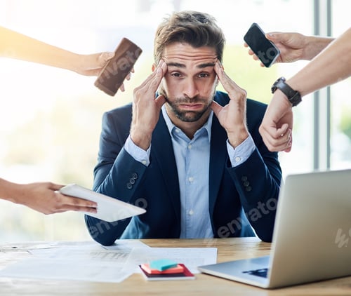 Preview: Portrait of a young businessman sitting at a desk surrounded by hands reaching in holding items