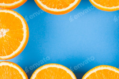 Preview: Cut Halves Of Juicy Orange On Blue Background. Orange Fruit, Citrus Minimal Concept. Creative