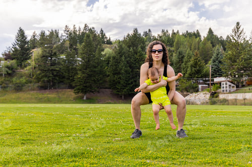 Preview: Active Woman Exercising Outdoors with Baby in Park