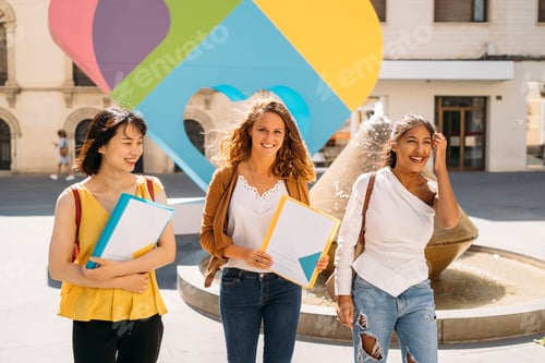Preview: University exchange students walking and smiling on campus