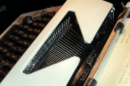 Preview: Close-Up of Vintage Typewriter Keys with Paper Roll for Writing and Reflection