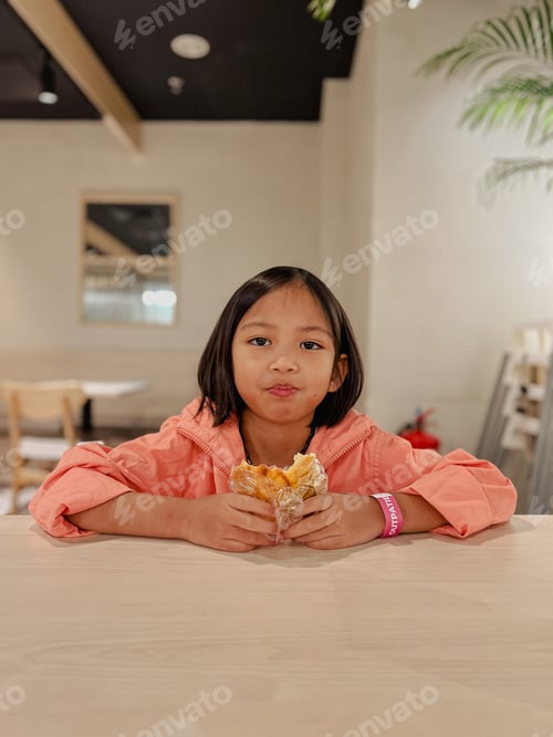 Child Enjoying a Delicious Snack Inside