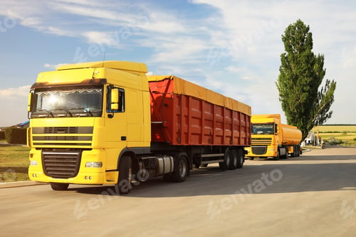 Preview: Modern bright trucks parked on country road