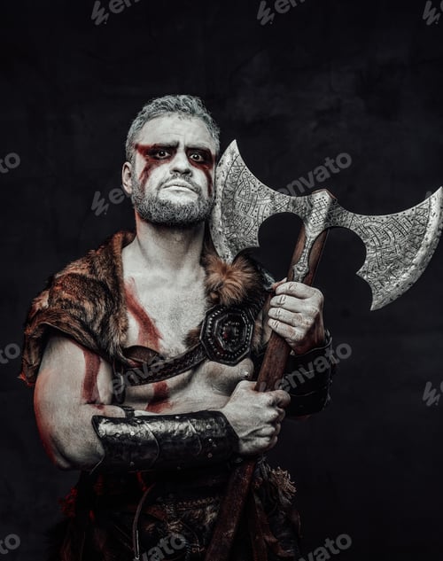 Preview: Barbaric mythical soldier with painted skin and axe in studio