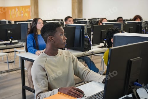 Preview: Young multiethnic students using computer inside university classroom