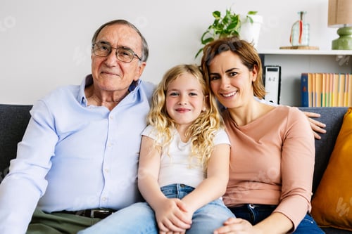 Preview: Three Family Members Sitting Together on Couch