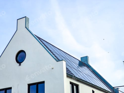 Preview: Newly build houses with solar panels attached on the roof against a sunny sky