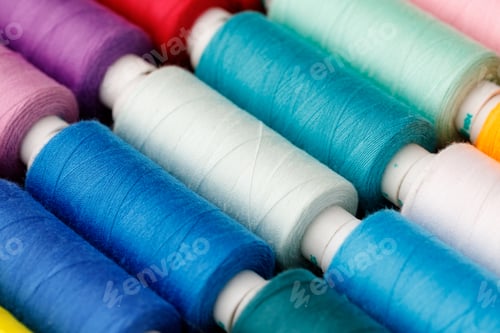 Preview: Close up of colored thread coils, thread spools background
