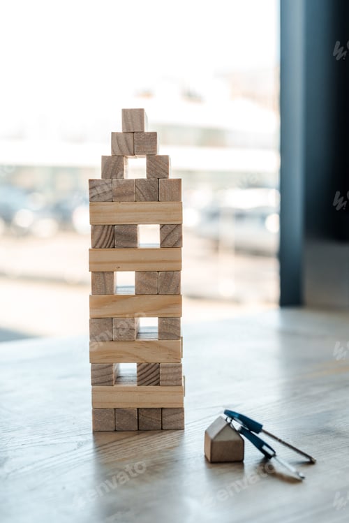 Preview: KYIV, UKRAINE - NOVEMBER 22, 2019: blocks wood tower game near key on desk