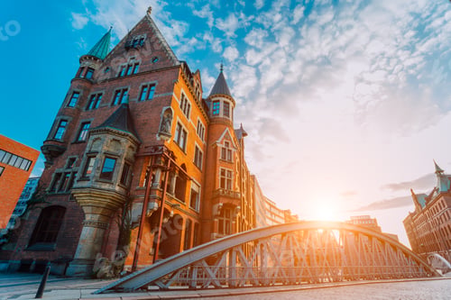 Preview: Metal arch bridge and old red bricks building in the Speicherstadt warehouse district of Hamburg