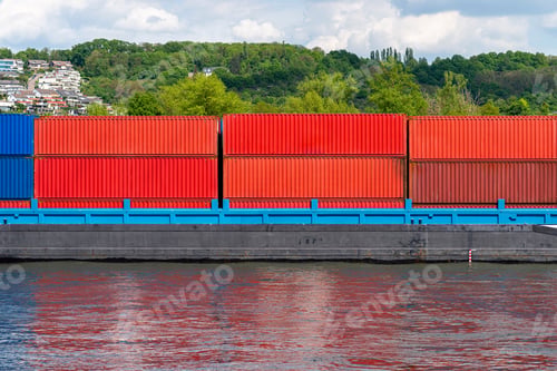 Preview: A barge carrying many containers on the Rhine in western Germany, trees and buildings in background