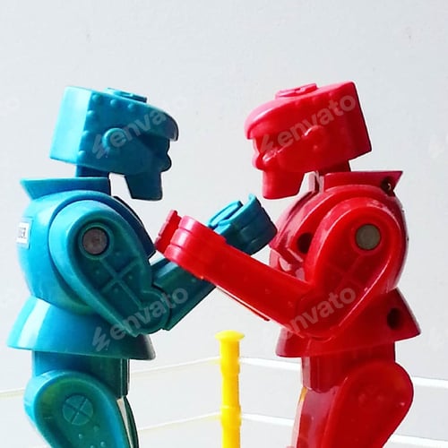 Preview: Side view of red and blue toy boxing figures against white background