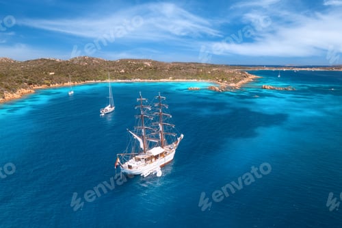 Preview: Aerial view of sail boat and luxury yachts on blue sea at sunset