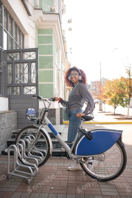Preview: Beaming student leaving her bike before entering university