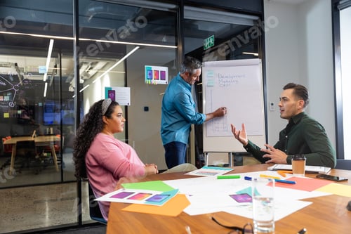 Preview: Multiracial businessman and businesswoman discussing strategy in meeting at office