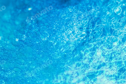 Preview: Closeup of blue translucent soap bubbles floating on the water surface, perfect for backgrounds