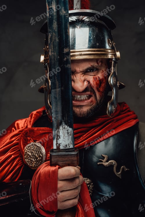 Preview: Mad warrior from rome staring at camera holding sword