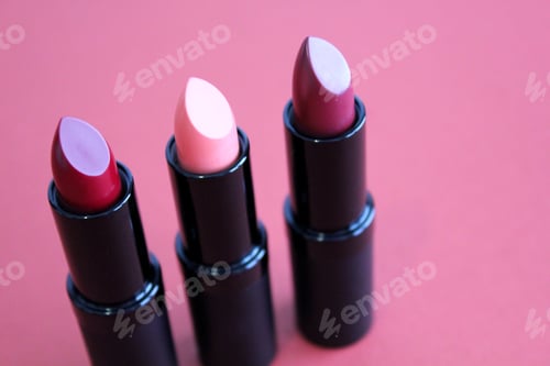 Preview: Three different shades of lipstick on a dusky pink background