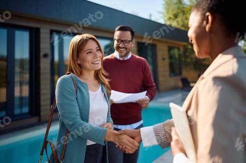 Preview: Happy couple coming to an agreement with real estate agent.