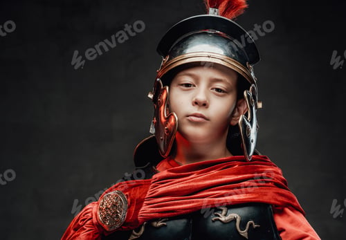 Preview: Dressed in legionary clothing cheerful boy in dark background