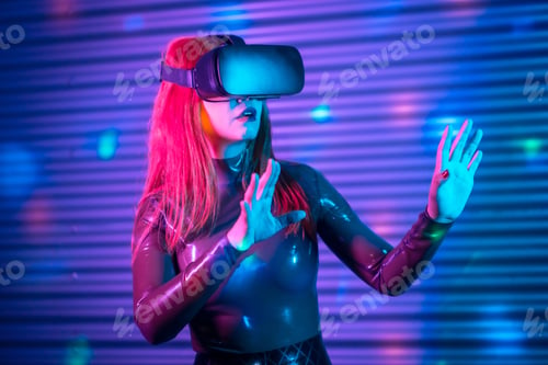 Preview: Futuristic shocked woman gesturing while wearing VR goggles