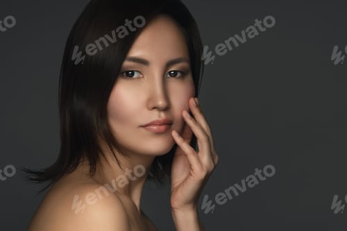 Preview: Portrait of young and beautiful asian woman on gray background