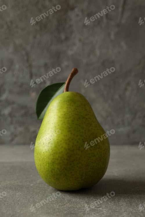 Preview: Fresh green pear on gray background, close up