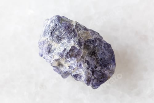 Preview: sample of rough cordierite mineral on white marble