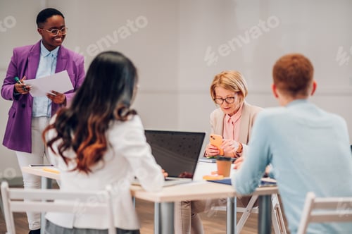 Preview: Multiracial business group of people having a meeting in an office