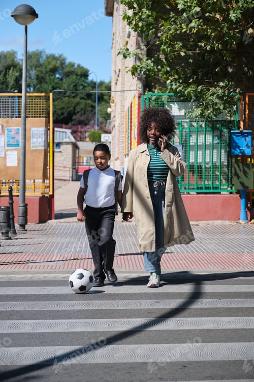 Preview: Mother and Son Crossing Street with Soccer Ball