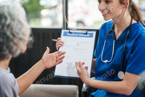 Preview: Caucasian female doctor delivers the results health check elderly Asian patient both seated sofa