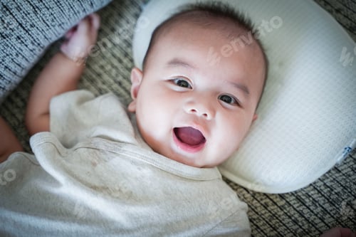 Preview: Cute three months old Caucasian baby boy on bed, Baby boy smile, top view.