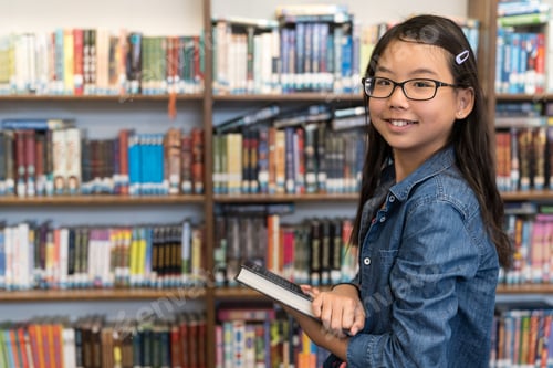 Preview: Asian teenage girl with eyeglasses in school library