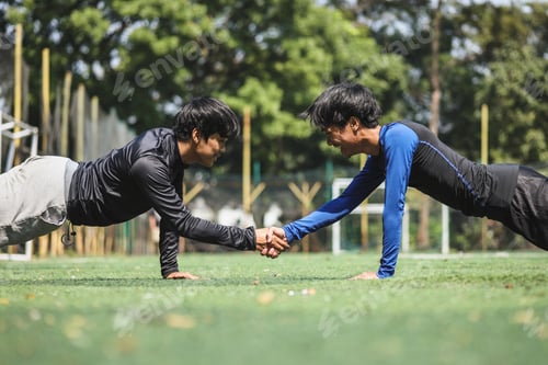 Preview: Two Asian young man doing push-ups together outdoor