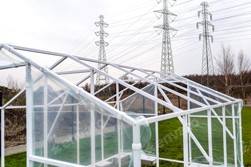 Preview: Assembling a home greenhouse from an aluminum frame and thick foil.